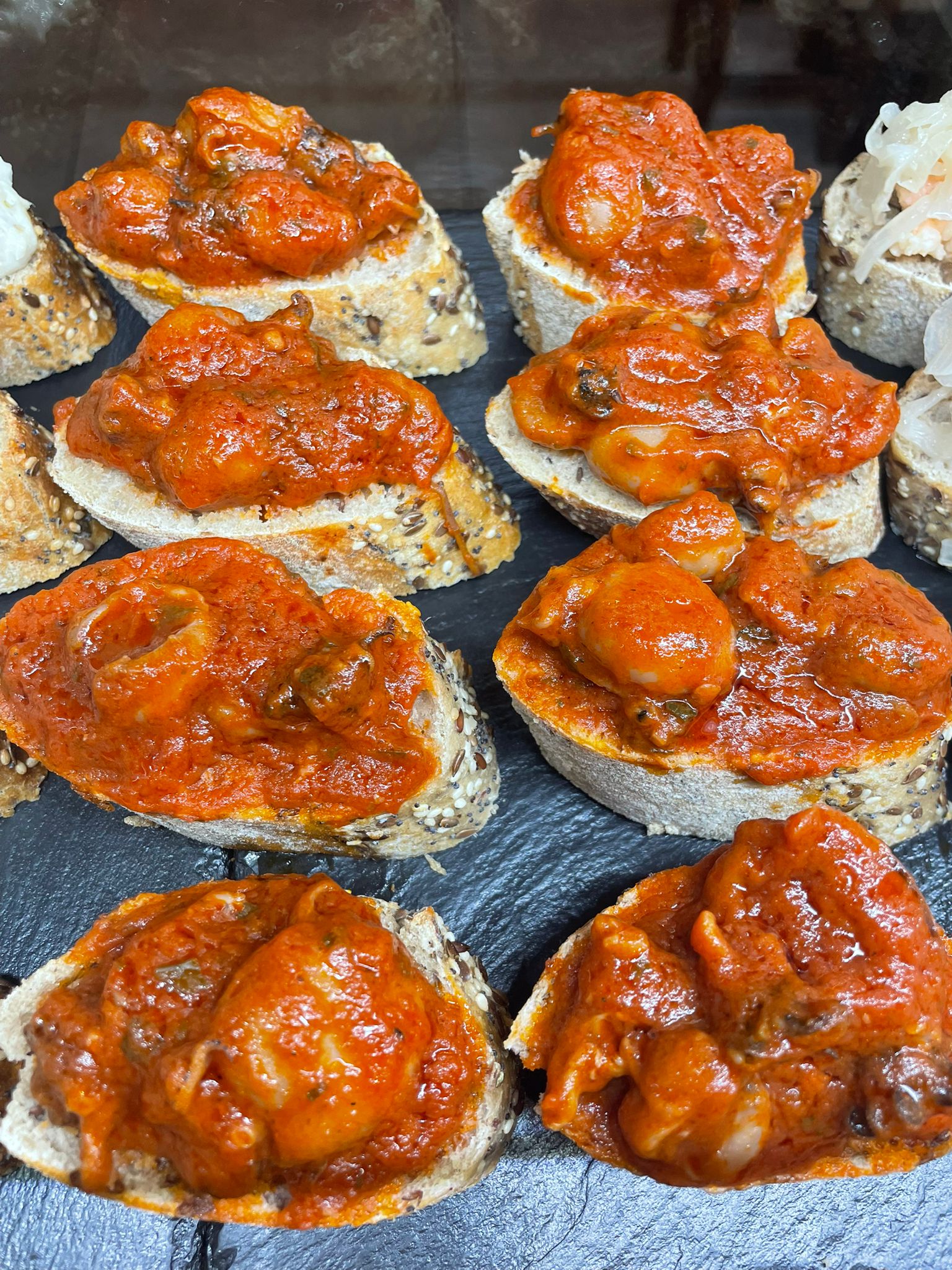 Cicchetti di pesce con sugo rosso, specialita bacaro veneziano